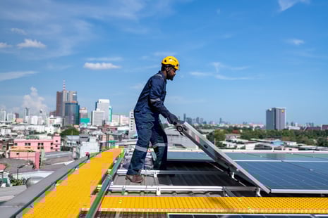 engineers-walking-on-roof-holding-solar-cell-panel-2023-11-27-05-08-38-utc