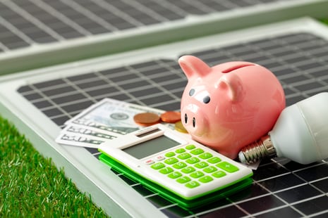 solar-panel-model-and-piggy-bank-close-up-2023-11-27-05-26-30-utc