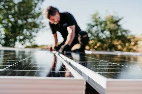 technician-assembling-solar-panels-on-house-roof-f-2022-10-11-20-15-32-utc (1)