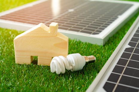 wooden-house-miniature-and-solar-panel-close-up-2023-11-27-05-11-26-utc