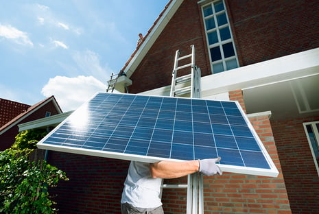 worker-climbing-ladder-carrying-solar-panel-for-ro-2022-03-07-23-56-25-utc