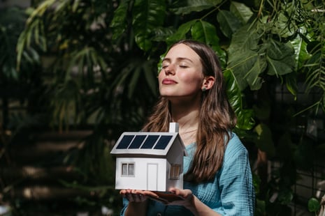 young-woman-in-jungle-holding-paper-model-of-house-2024-10-19-23-38-02-utc